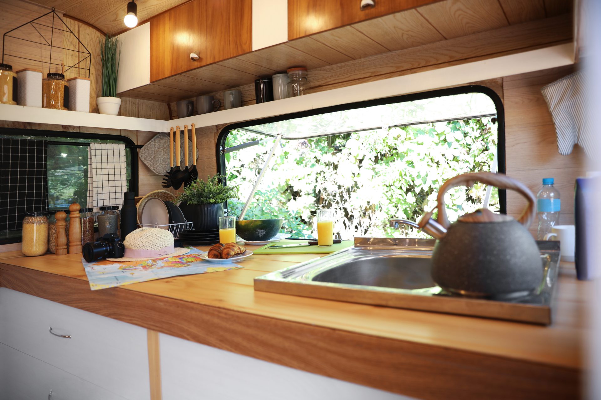 stylish-kitchen-interior-with-different-accessories-and-utensils-in-modern-trailer-camping-vacation