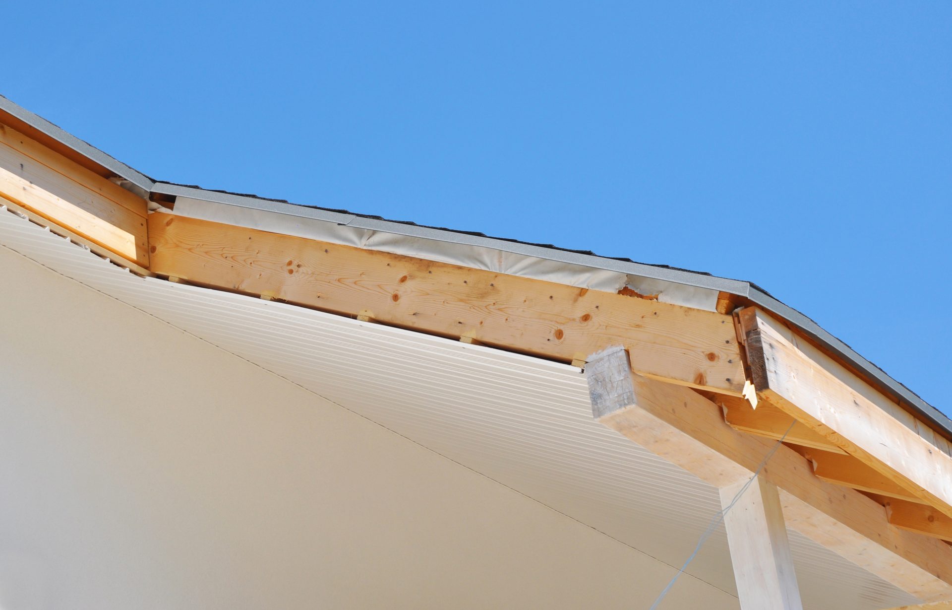 close-up-on-house-roofing-construction-with-installing-soffits-and-fascia-boards